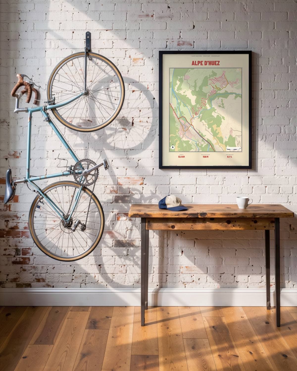 Alpe d'Huez Carte Routière map poster in a black frame (45 × 60 cm) in a brick loft with a vintage bike