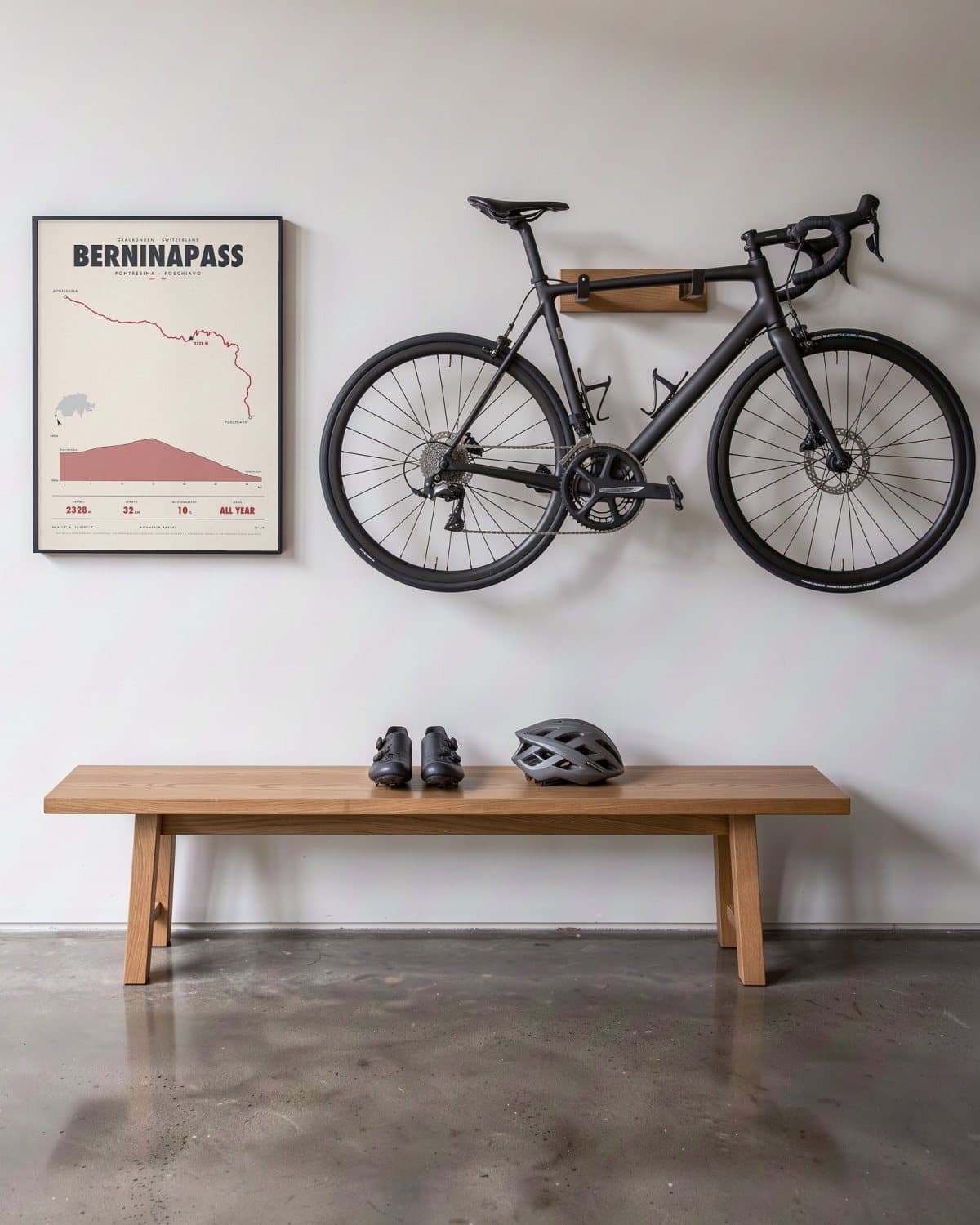 Berninapass mountain pass poster in a black frame (45 × 60 cm) in a hallway beside a road bike