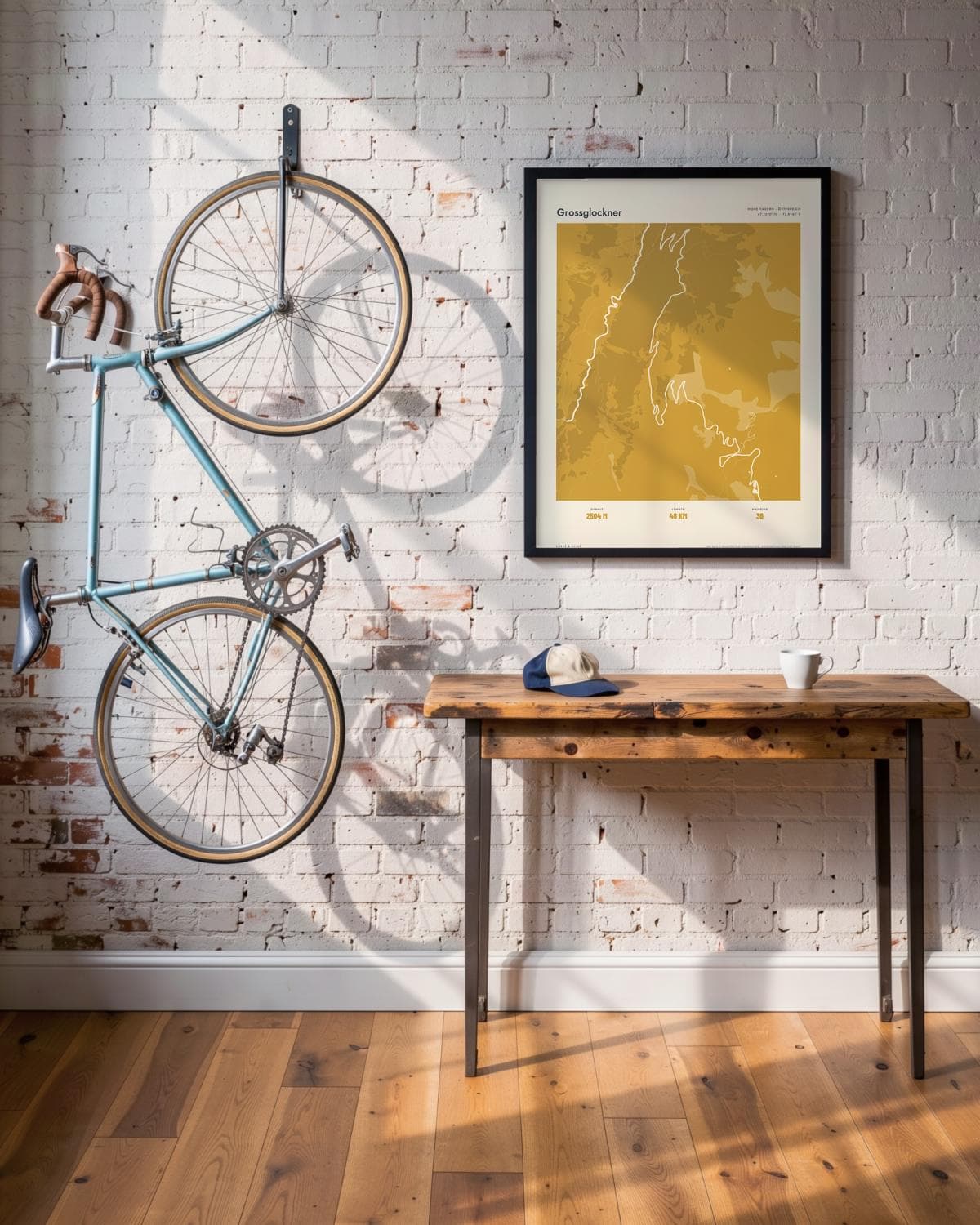 Grossglockner Atlas Mustard map poster in a black frame (45 × 60 cm) in a brick loft with a vintage bike