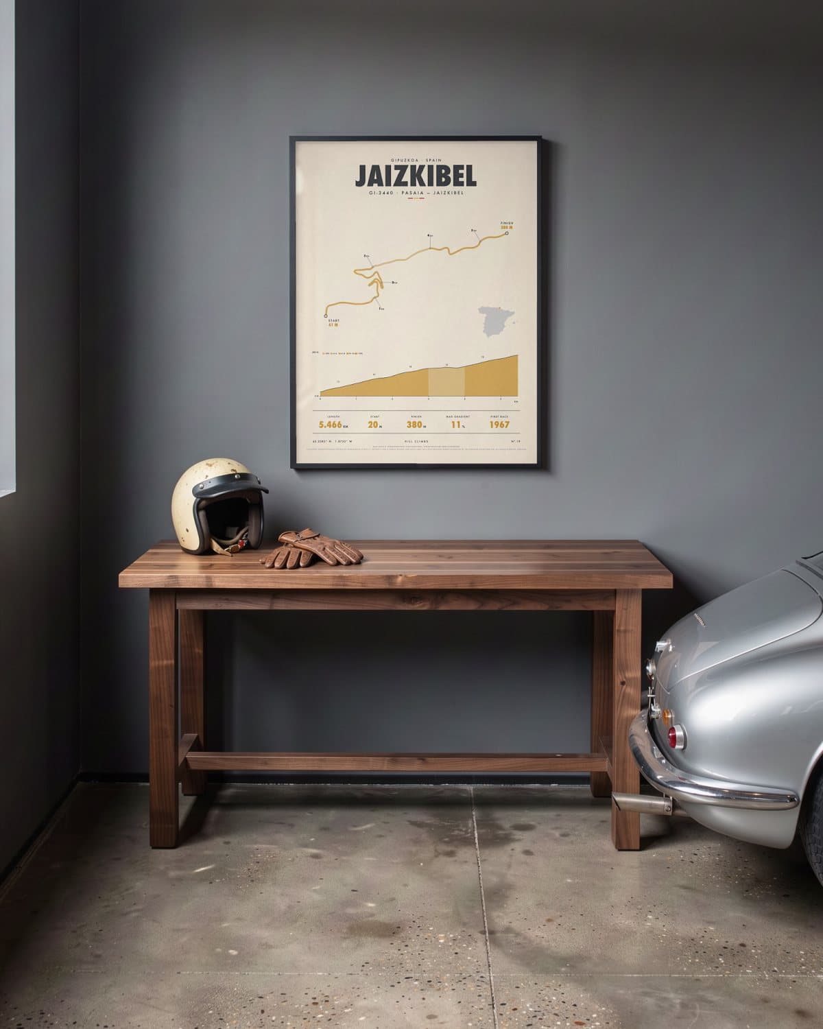 Jaizkibel hill climb poster in a black frame (45 × 60 cm) in a home garage