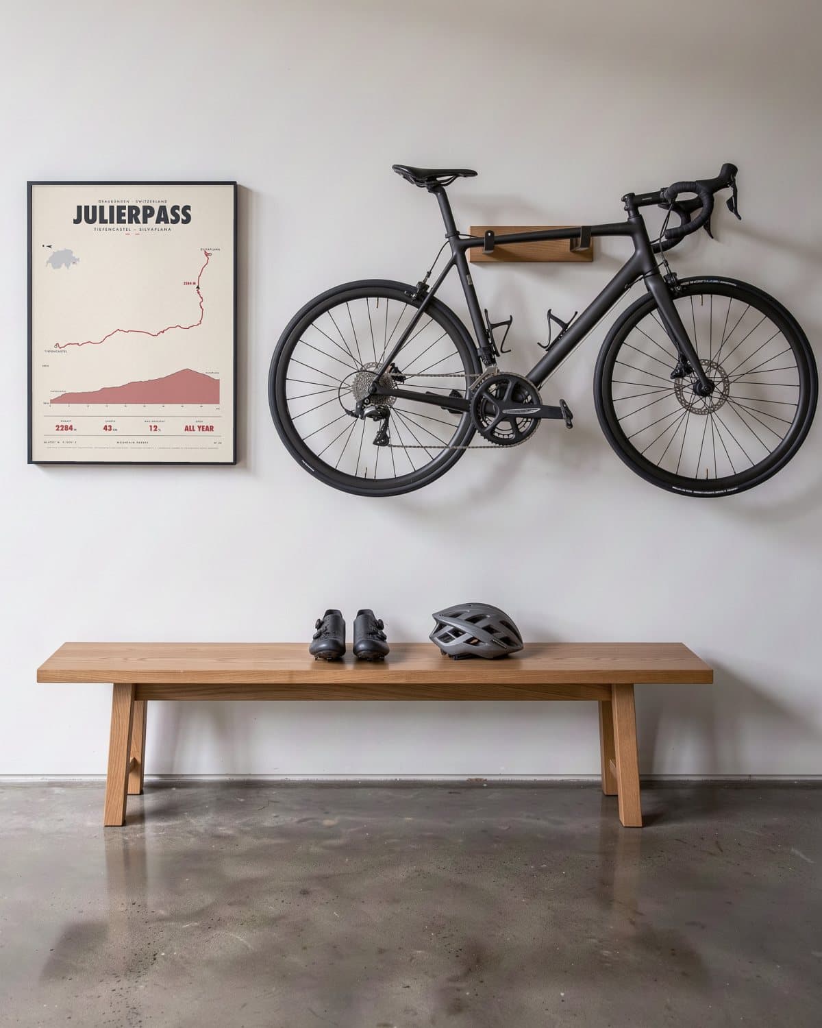 Julierpass mountain pass poster in a black frame (45 × 60 cm) in a hallway beside a road bike