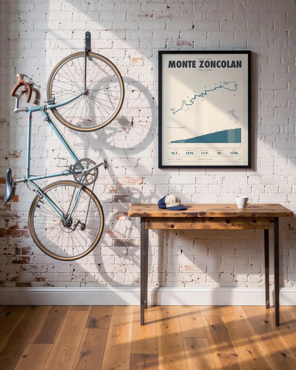 Monte Zoncolan cycling climb poster in a black frame (45 × 60 cm) in a brick loft with a vintage bike