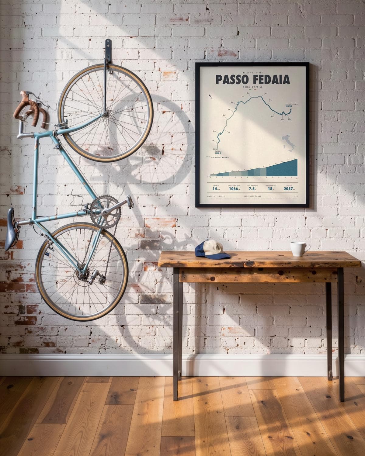 Passo Fedaia cycling climb poster in a black frame (45 × 60 cm) in a brick loft with a vintage bike