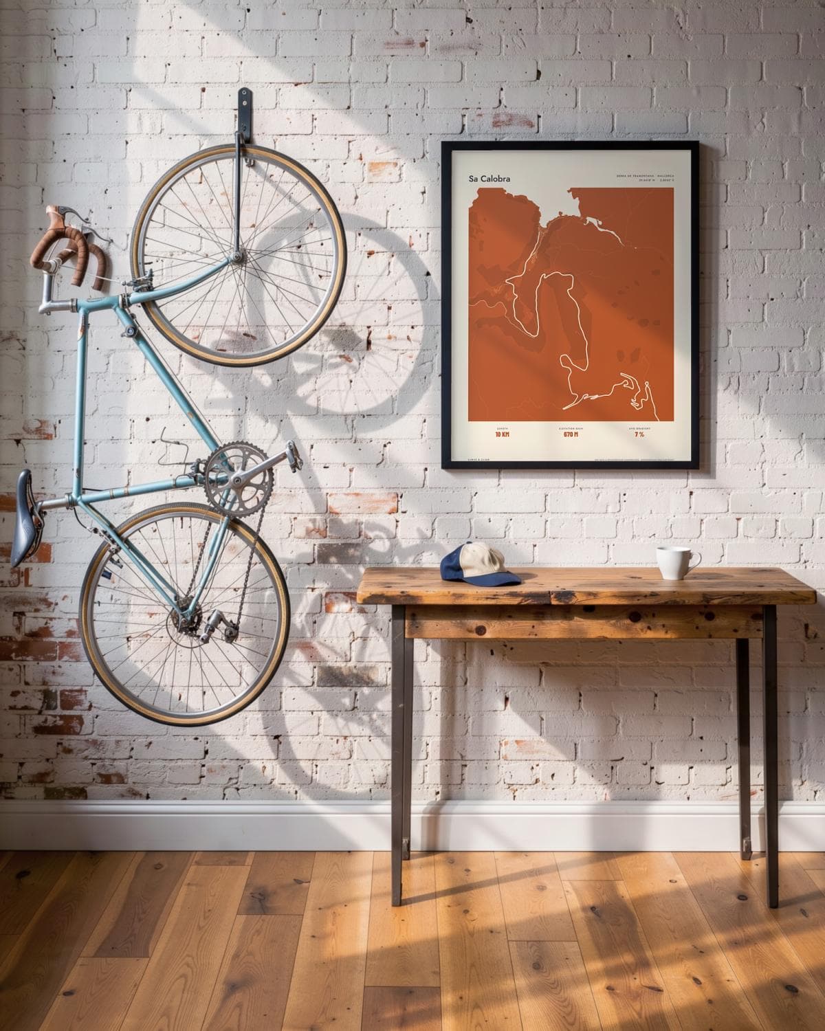 Sa Calobra Atlas Burnt Orange map poster in a black frame (45 × 60 cm) in a brick loft with a vintage bike
