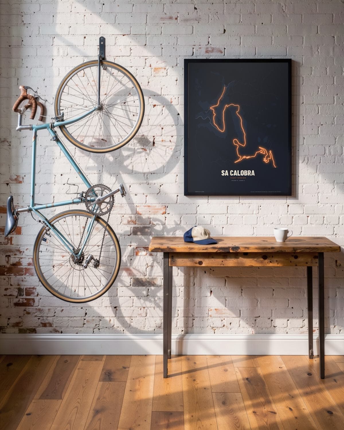 Sa Calobra Night Session map poster in a black frame (45 × 60 cm) in a brick loft with a vintage bike