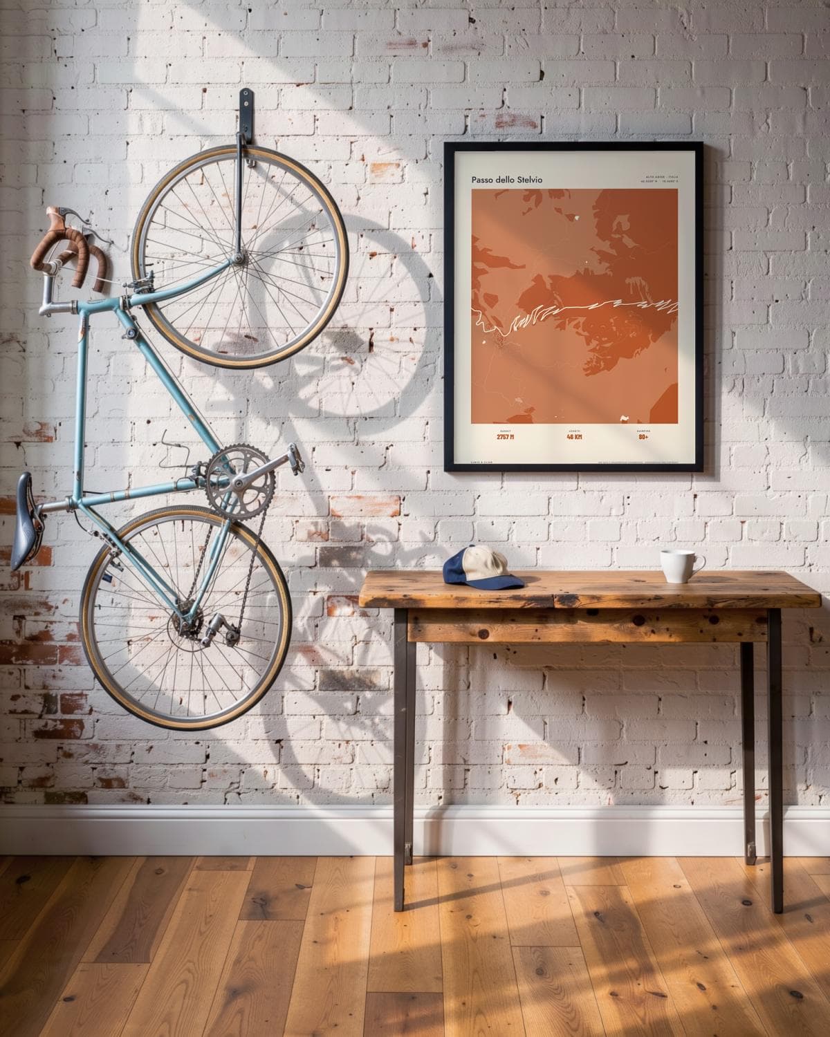 Passo dello Stelvio Atlas Burnt Orange map poster in a black frame (45 × 60 cm) in a brick loft with a vintage bike