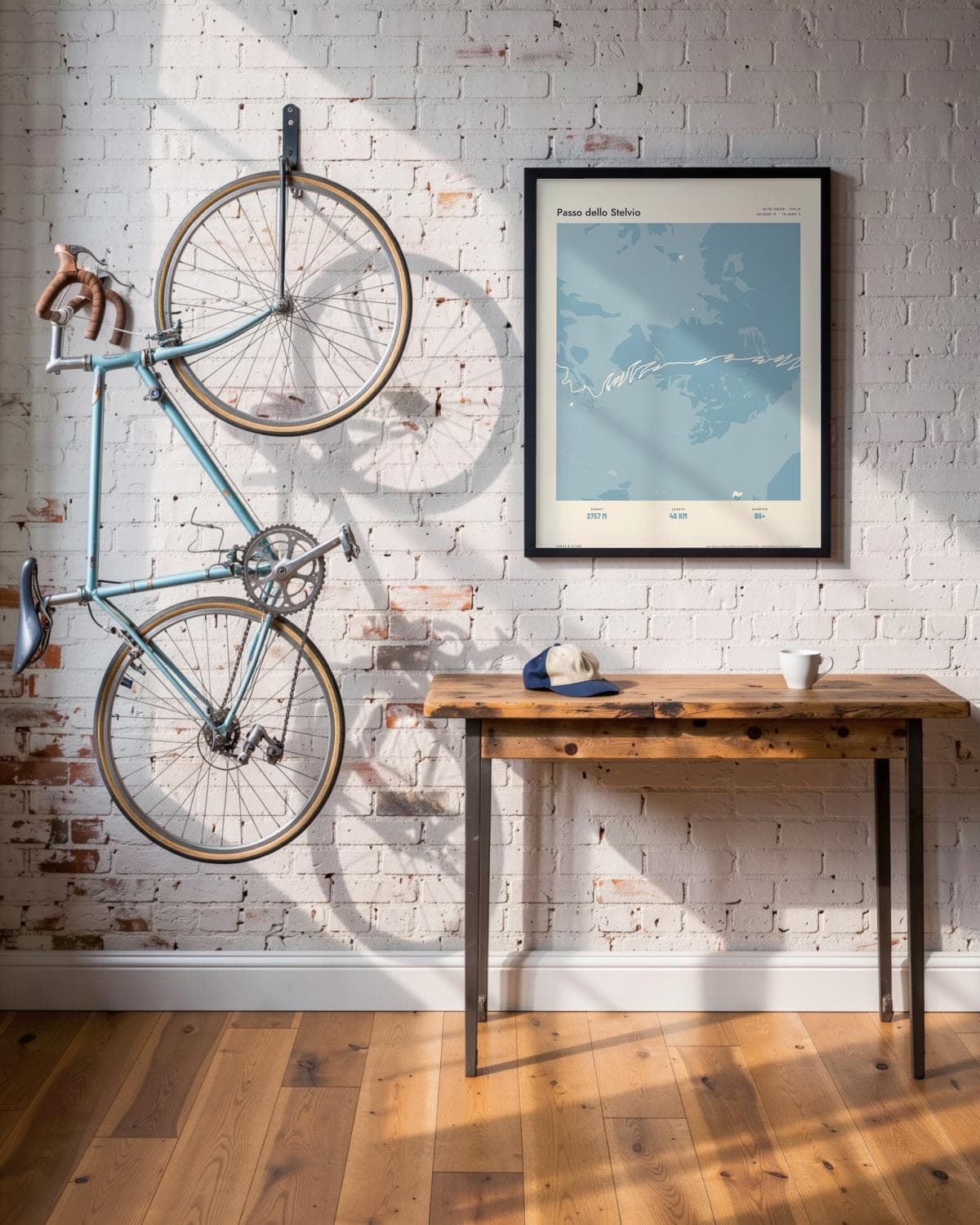 Passo dello Stelvio Atlas Dusky Blue map poster in a black frame (45 × 60 cm) in a brick loft with a vintage bike
