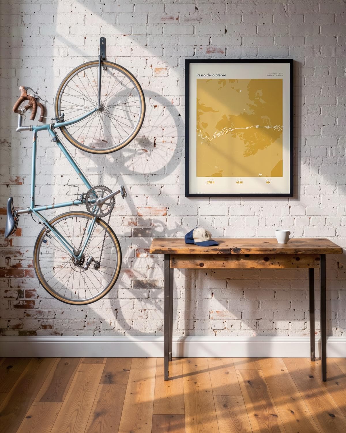 Passo dello Stelvio Atlas Mustard map poster in a black frame (45 × 60 cm) in a brick loft with a vintage bike