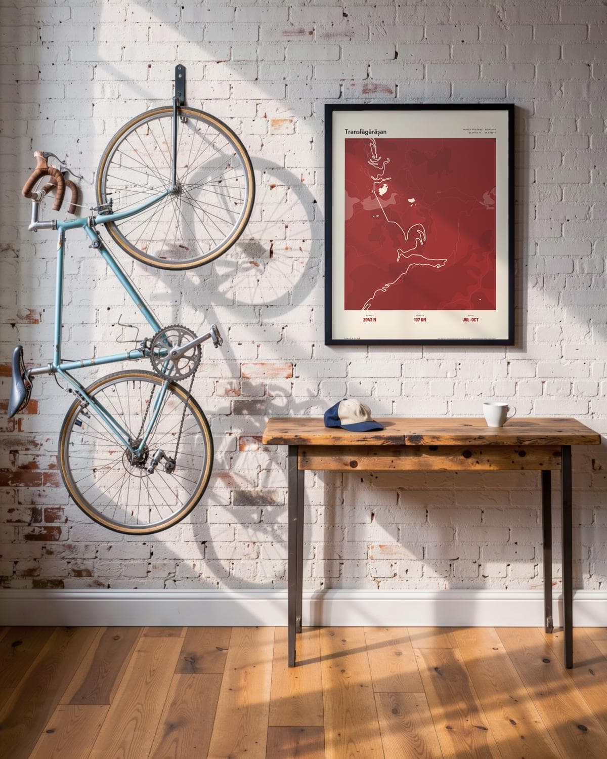 Transfăgărășan Atlas Deep Red map poster in a black frame (45 × 60 cm) in a brick loft with a vintage bike