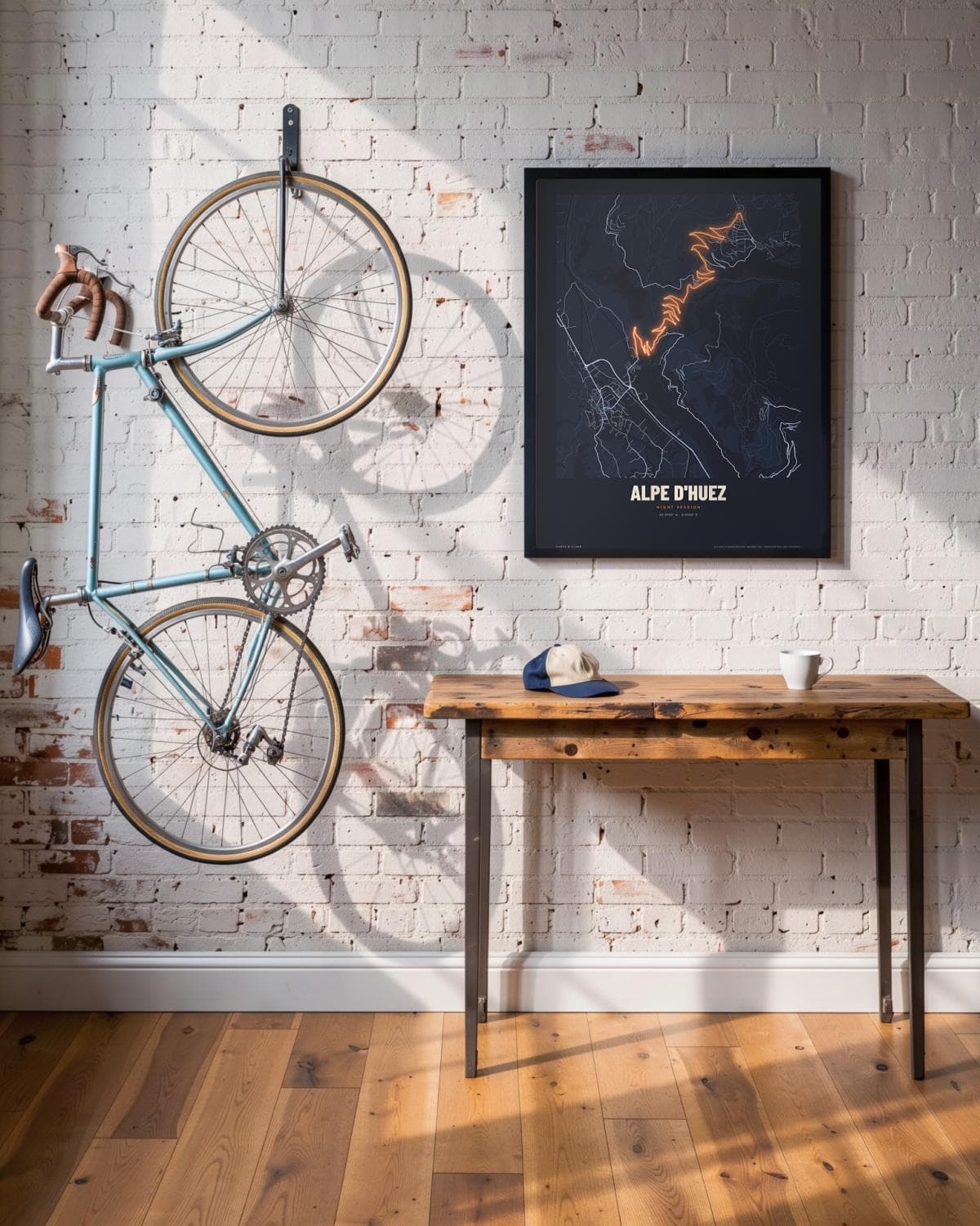 Alpe d'Huez Night Session map poster in a black frame (45 × 60 cm) in a brick loft with a vintage bike