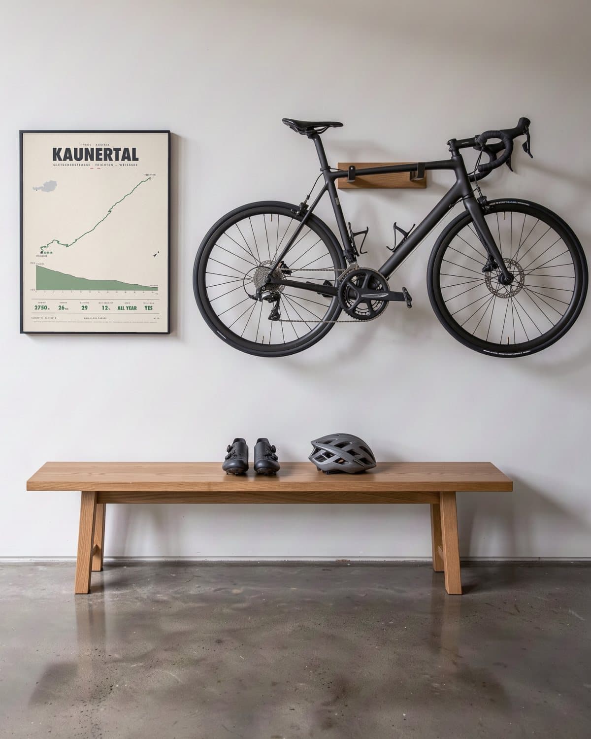 Kaunertal mountain pass poster in a black frame (45 × 60 cm) in a hallway beside a road bike