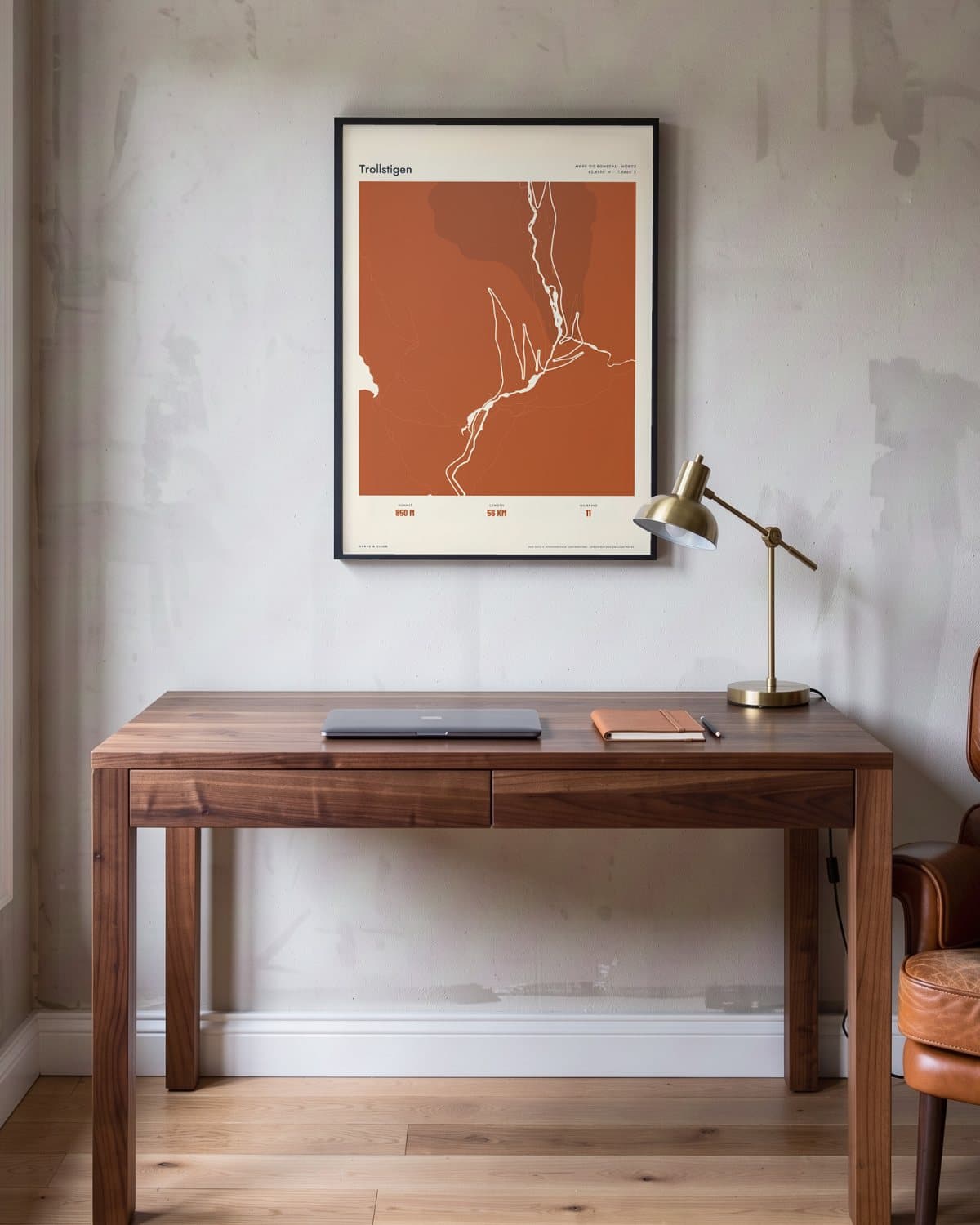 Trollstigen Atlas Burnt Orange map poster in a black frame (45 × 60 cm) in a home office