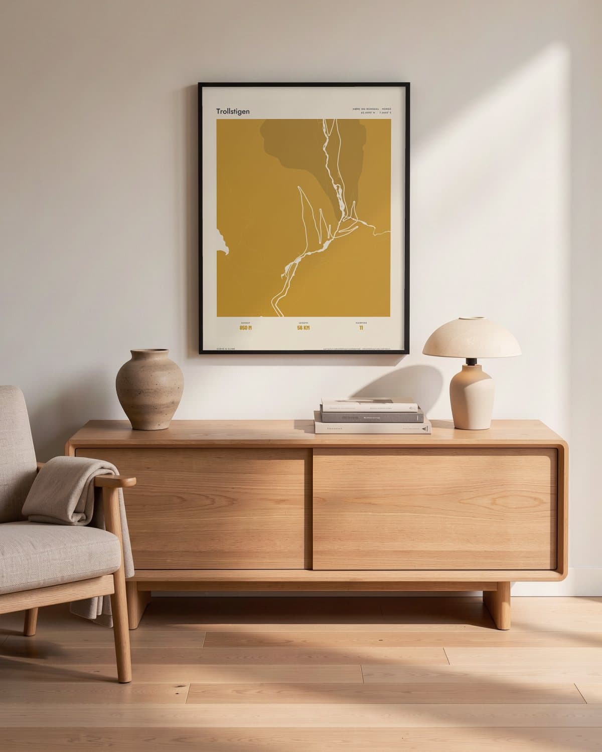 Trollstigen Atlas Mustard map poster in a black frame (45 × 60 cm) in a living room